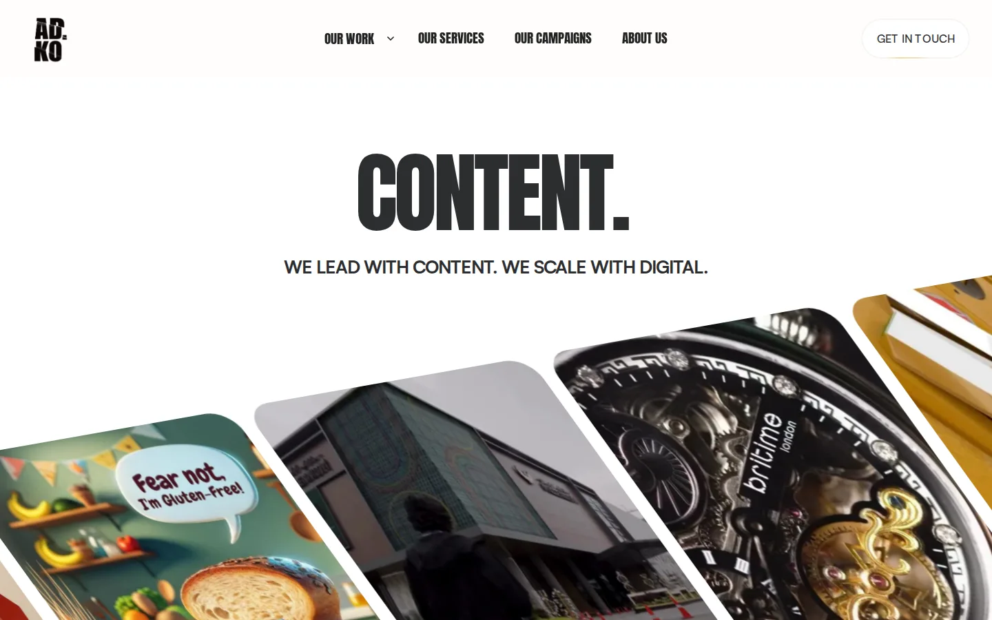 Adko homepage at 1440×900: off-white ground, one huge condensed black word centred, a fan of tilted work cards below.